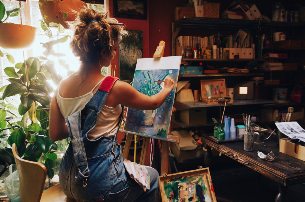 Unlocking Creativity: Strategies for Inspiring Innovation - woman paints a floral painting in hobby room